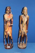 A pair of carved Tribal figures, some beading missing, 23 1/2" tall.