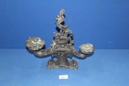 An unusual and heavy bronze figure of a five-toed Dragon breathing fire and gazing up at a flaming