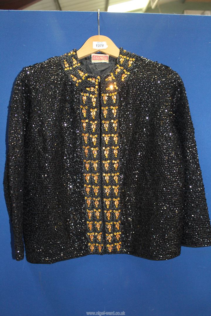 A ladies short evening jacket with all over black sequins and black and gold glass bead