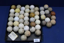 A tray of old Golf balls from 1920's onwards, plus thirteen mesh & recess pattern golf balls.