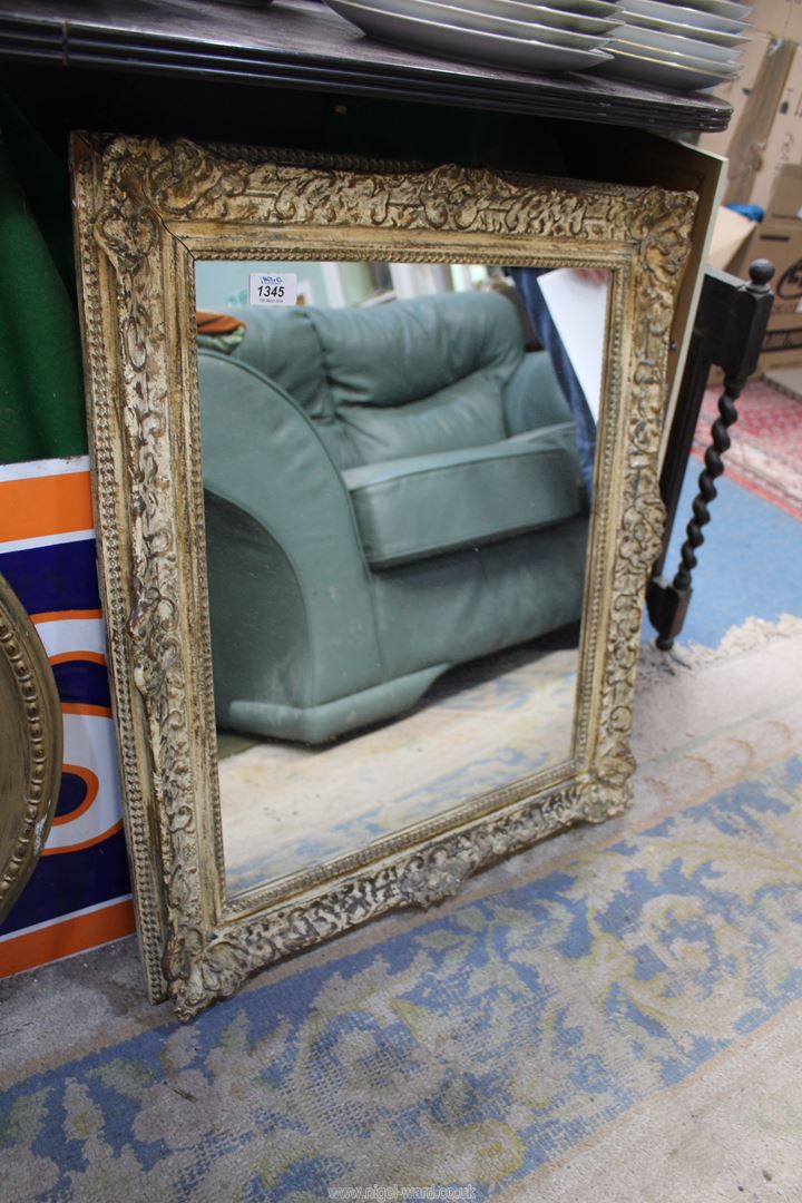 A rectangular, ornate frame mirror, 23" x 25 1/2".