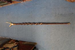 A twisted wood (possibly Willow) Walking staff having bound Antler thumb stick, 53" long.