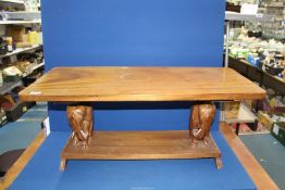 A Coffee table with two carved elephants to base, 3' long x 16" wide x 15" high.