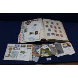 A red Stamp Album containing Stamps and First Day Covers including; English and Foreign stamps,