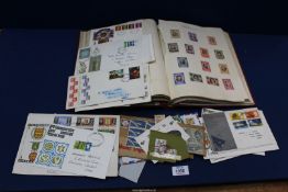 A red Stamp Album containing Stamps and First Day Covers including; English and Foreign stamps,