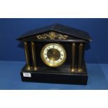 A slate Mantle Clock with gilt pillars, the movement by F. Martin, Paris, 13'' wide x 10 1/2'' high.