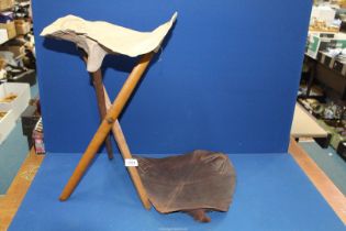 A Campaign folding tripod stool, 19th century, with both leather and canvas seating slings.