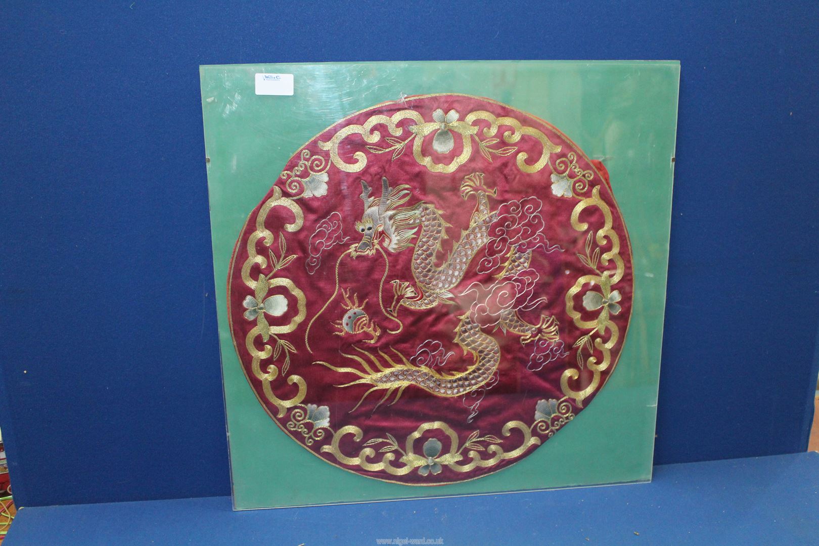 An oriental circular embroidery of a Dragon, 17 1/2" diameter.