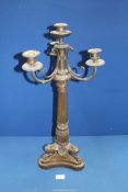 A heavy bronze metal four light Candelabrum having a tapering reeded column, swept sconce supports,