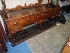 A circa 1800 Oak pot board Dresser Base having three frieze drawers,