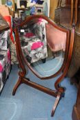 An attractive boxwood strung Mahogany framed bevelled swing Mirror of shield shape,
