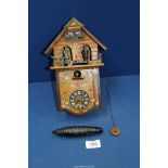 A small German Cuckoo clock with pendulum and weight (bellows in need of repair).