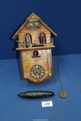 A small German Cuckoo clock with pendulum and weight (bellows in need of repair).