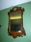 A Georgian type fretworked Walnut framed wall hanging Mirror, some losses, 27'' x 16 1/2''.