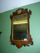 A Georgian type fretworked Walnut framed wall hanging Mirror, some losses, 27'' x 16 1/2''.