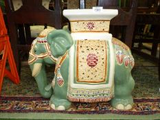 A porcelain conservatory stool/jardiniere stand in the form of a ceremonial Elephant, 17 1/2" tall.