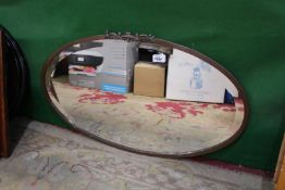 An Arts & Crafts style oval copper framed wall mirror, 29 1/2" x 17".
