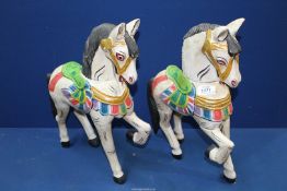 A pair of brightly painted wooden fairground style horses, 16 1/2" high.