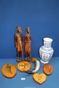 Two African carved figures with beading, 19" high, a cow horn leather covered water bottle (a/f.