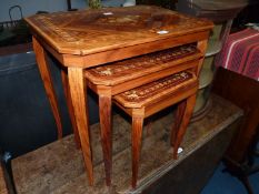 An Italian type Nest of Tables, of inlaid mixed woods depicting stylised flowering plants,