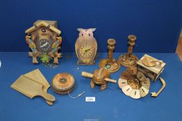 A box of treen including; cuckoo & wobble eye clock, butter pats, etc.