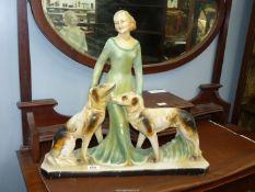 An Art Deco chalk figure of Lady with dogs, 23" x 21" high, some wear.