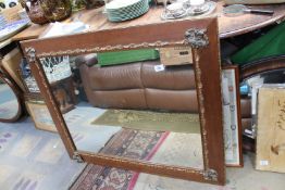 A large wall mirror with broad wooden frame having metal and gilt detail, 40" x 32 1/2".