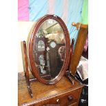 A Mahogany framed oval swing Mirror, 18 1/2'' wide x 27 1/2'' high.