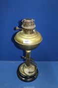 A brass oil lamp, partly converted to electric having an Art Nouveau base, 18" tall.