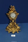A gilded Mantle clock with stones around bezel, 11" tall.
