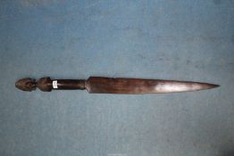 A tribal carved ebony sword club, the pommel shaped as a head with elaborate crest, 38" long.