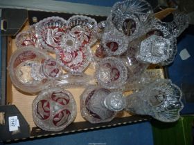 A quantity of pressed glass with cranberry panels including; vases, decanters, basket, etc.