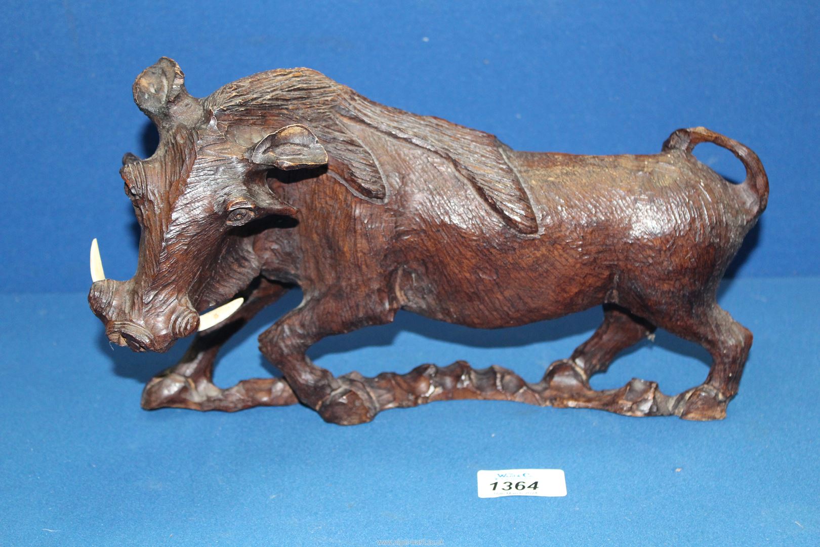 A nicely modelled carved figure of a Warthog, 12'' long x 8'' high.