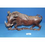 A nicely modelled carved figure of a Warthog, 12'' long x 8'' high.