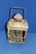A brass Oil lamp in lantern style case, 16" tall x 9" x 7 1/2" (glass panels missing).