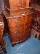 A contemporary bow fronted Walnut/Mahogany Chest of four long Drawers,