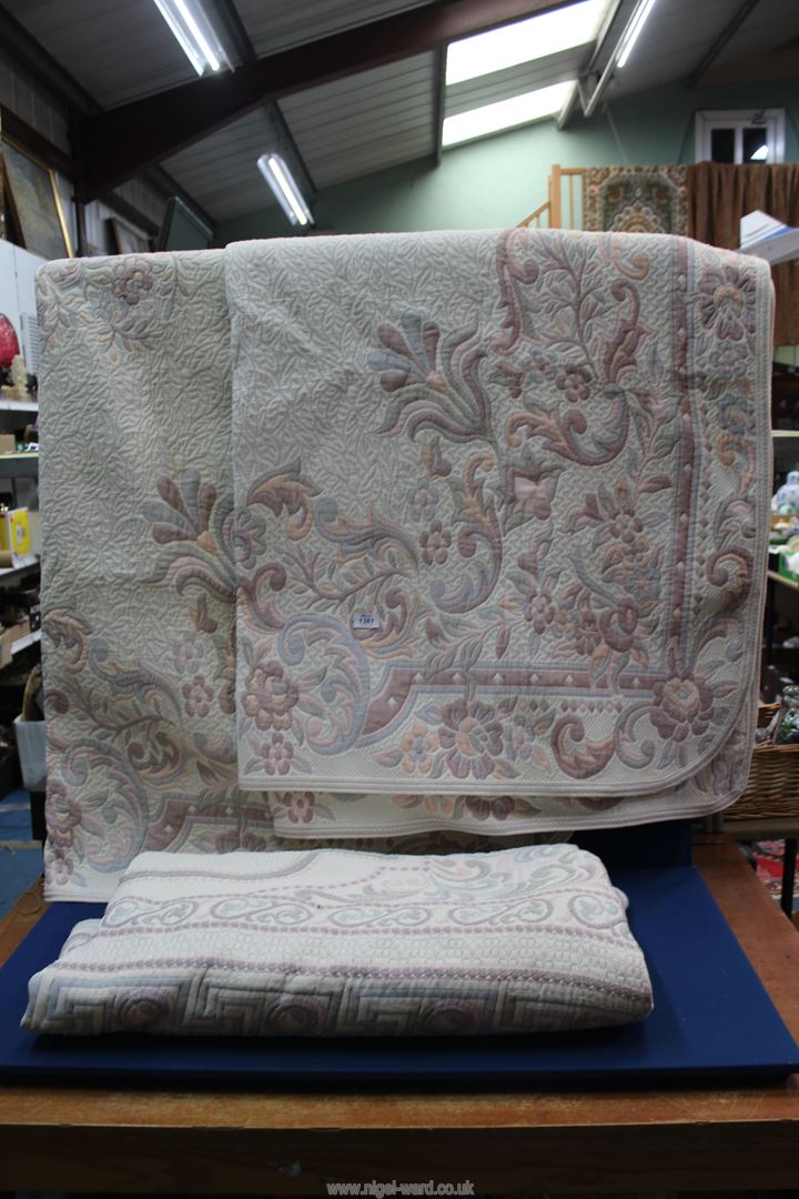 A pair of single bed covers and a double one in similar pattern, all reversible.