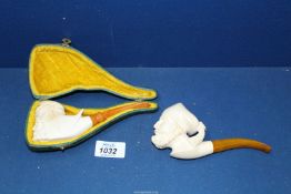 Two meerschaum Pipes, one pipe cased, carved with the head of a bearded Arab with headdress,