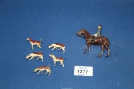 A lead huntsman figure and five hounds (a/f).