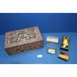 A finely carved Oriental box with three section interior decorated with dragons containing