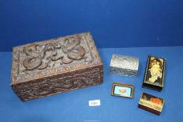A finely carved Oriental box with three section interior decorated with dragons containing