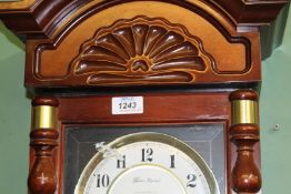 An Oak cased Wall Clock having a two train spring driven movement (ran briefly during lotting),
