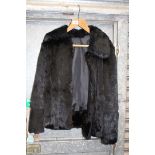 A black Mink fur ladies Jacket, (hole to lining, has been shortened), size L.