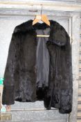 A black Mink fur ladies Jacket, (hole to lining, has been shortened), size L.
