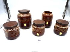 Five Cornish Fosters Pottery storage jars including utensil pot and a biscuit barrel.