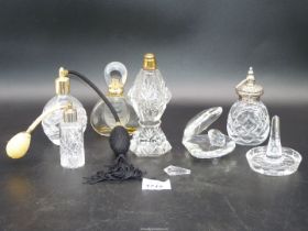 A quantity of cut glass atomizers including one with hallmarked silver top,