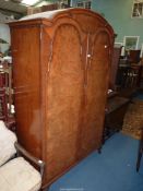 A matching cross-banded Walnut Wardrobe with hanging rails and an upper shelf and raised on brief