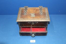 An embossed leather covered JewelleryBox with metal hinges and handles, 9 1/2" x 5 1/2" high.