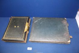 An old photograph album with clasp (empty) and another old photograph album of pictures of house