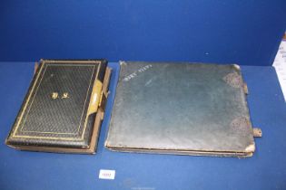 An old photograph album with clasp (empty) and another old photograph album of pictures of house